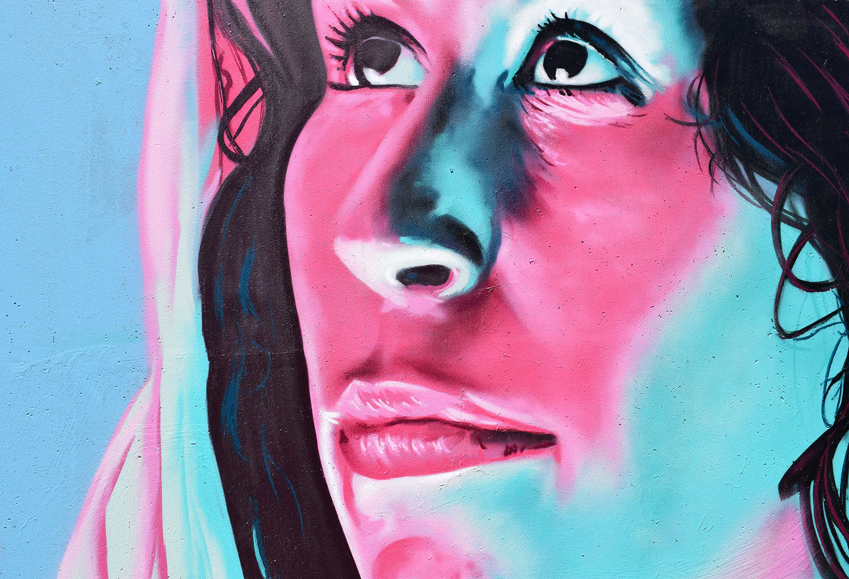 Close-up of a woman's face with vibrant pink and blue lighting. Close-up of a woman's face with vibrant pink and blue lighting.